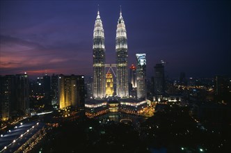 MALAYSIA, Kuala Lumpa, Petronas Towers and city skyline illuminated at sunset