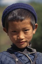 NEPAL, Annapurna Region, Bhadauri, Head and shoulders portrait of young Gurung boy in Bhadauri