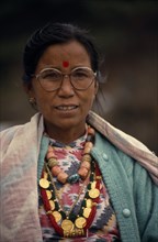 NEPAL, Annapurna Region, Larjung, Circuit Trek. Portrait of Thakali woman wearing traditional dress