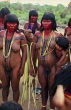 BRAZIL, Mato Grosso, Indigenous Park of the Xingu, Panara women painted with red karajuru and