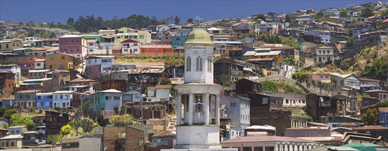 CHILE, Valparaiso, The steeple of Iglesia Matriz with typical Valparaiso housing rising behind.