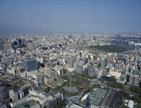 JAPAN, Honshu, Tokyo, "Cityscape from Tokyo Tower with high rise buildings, car park, sports courts