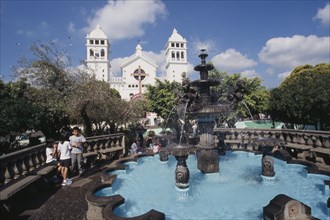 EL SALVADOR, Juayua, Temple del Senor de Juayua and Plaza.  Children beside fountain in foreground