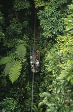 COSTA RICA, Landscape, Rainforest, Tourists in aerial tram through rainforest near Braulio Carillo