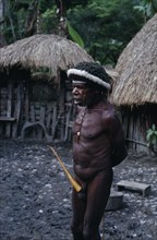 INDONESIA, Irian Jaya, Baliem  Valley, "Old male Dani warrior wearing penis gourd and luck charms.