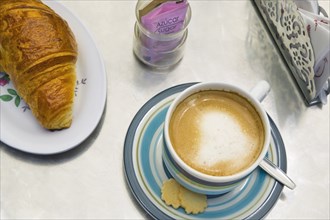 CHILE, Santiago, Coffee and croissant in one of the numerous cafes in the city centre.