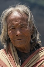 NEPAL, Lower Dolpo Trek, Gomba , Head and shoulders portrait of elderly woman in Gomba Village