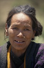 NEPAL, Lower Dolpo Trek, Bhang Kharka, Head and shoulders portrait of a woman wearing a nose