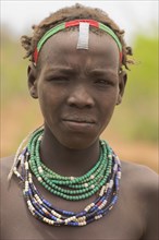 ETHIOPIA, Lower Omo Valley, Village near Omorate, Dassanech girl