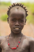 ETHIOPIA, Lower Omo Valley, Village near Omorate, Dassanech girl
