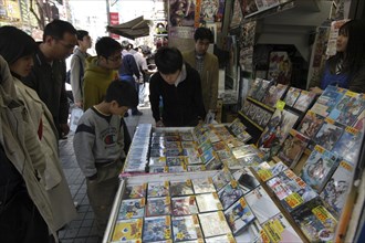 JAPAN, Honshu, Tokyo, Harajuku - boys and men shopping at a used software shop for video games