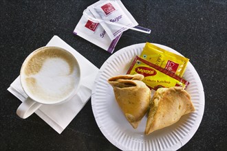 INDIA, Food, Cappuccino and samosas in a modern coffee shop.