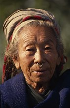 NEPAL, East, Palati, Head and shoulders portrait of elderly woman wearing a nose ring in Palati