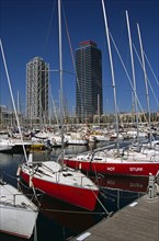 SPAIN, Catalonia, Barcelona, "Port Olimpic, Yachts in marina, Hotel Arts and Torre Mapfre."