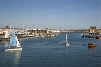 ENGLAND, West Sussex, Shoreham-by-Sea, People sailing their dingies in the river Adur next to the