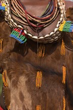 ETHIOPIA, Omo Valley, Mago National Park, Womans necklaces and traditional goatskin dress decorated