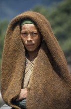 NEPAL, Dhorpatan Trek, Gurjakot, Portrait of Herdswoman wearing a yak wool blanket over her head