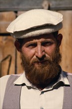 PAKISTAN, North West Frontier, Chitral, Head and shoulders portrait of a man with a beard wearing a