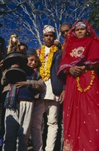 NEPAL, East,  Sangawa Khola, Bride and groom during wedding procession. Groom wearing a marigold