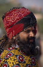 INDIA, Rajasthan, Bikaner, Portrait side profile of a Rajput man with a beard wearing a turban at