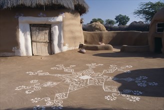 INDIA, Rajasthan, Katariasar, Village hut decorated for the Camel Festival with white painted