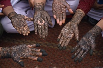 INDIA, Rajasthan, Nawalgarh, Detail of a group of hands with various henna designs in the Mehndi