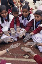 INDIA, Rajasthan, Nawalgarh, Schoolgirls displaying henna designs on their hands in the Mehndi