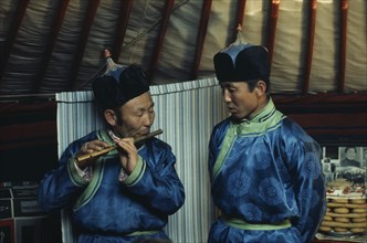 MONGOLIA, Gobi Desert, Biger Negdel, Flute player and chanter in fine traditional silk tunics