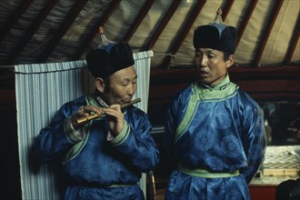 MONGOLIA, Gobi Desert, Biger Negdel, Flute player and chanter in traditional costume during