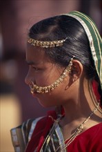 INDIA, Rajasthan, Jhunjhunu, Portrait side profile of a girl wearing traditional dress and
