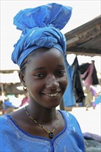 GAMBIA, Western Gambia, Tanji, Tanji Village.  Head and shoulders portrait of smiling African girl