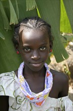 GAMBIA, Western Gambia, Tanji, Tanji village.  Head and shoulders portrait of smiling young girl