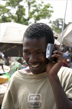 GAMBIA, Atlantic Coast, Banjul, "Albert Market, Russell Street.  Young African man smiling  while