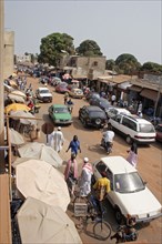 GAMBIA, Western Gambia, Serekunda, "Bakau Market,  Atlantic Road.  Main city road lined with street