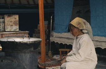 MONGOLIA, People, Khalkha winter sheep camp. Shepherd's wife cooking traditional meat dumplings