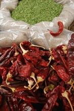 ISRAEL, Jerusalem, "Jerusalem food market.  Open sacks of dried, red, hot chili peppers and green