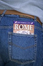 ITALY, Lazio, Rome, "The Eternal City of Rome guide book in tourists pocket,."