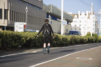ENGLAND, East Sussex, Brighton, Rollerblading on the seafront promenade.