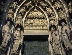 GERMANY, North Rhine Westphalia, Cologne, Cathedral doorway flanked by stone statues and decorative