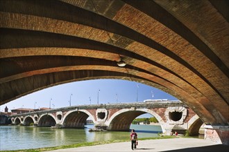 20091063 Pont Neuf  red brick bridge over river Garonne. French One individual Solo Lone Solitary Western Europe  Dominant RedDominant BlueArchitectureUrbanTransportWaterPeople - Single Person J...
