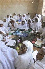 GAMBIA, Western Gambia, Tanji, Tanji Village.  African Muslim girls wearing white headscarves while