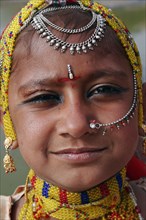 INDIA, Rajasthan, Jodhpur, Portrait of a young Indian girl at Meherangarh Fort wearing nose ring