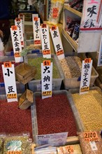JAPAN, Honshu, Tokyo, Tsukiji market.   Labelled boxes of seeds and pulses for sale at at the