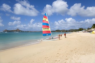 WEST INDIES, St Lucia, Gros Islet, Reduit Beach in Rodney Bay with tourists on the beach beside a