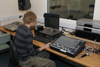CHILDREN, Education, Secondary, Students using sound desk in school recording studio.