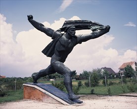 HUNGARY, Near Budapest, Statue Park. Communist statue of The striding soldier. Republic of Councils
