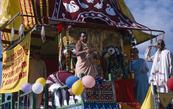 ENGLAND, East Sussex, Brighton, Hare Krishna taking part in a parade on Brighton seafront  with a