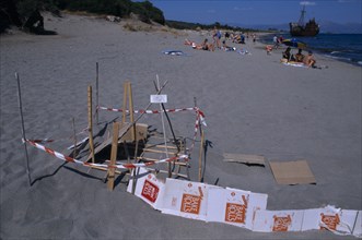 GREECE, Peloponnese, Sea Turtle protection consisting of wood and cardboard forming a cordon around