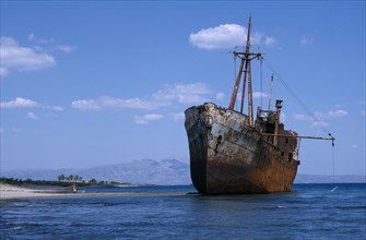 GREECE, Peloponnese, Shipwreck in shallow water next to sandy beach