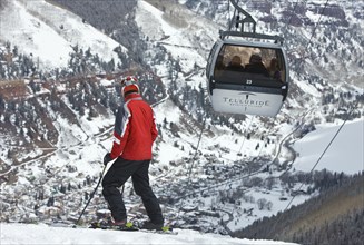 20091055 Skier slopes with cable car ski lift overhead passing by. Property Released American Automobile Automotive Cars Holidaymakers Motorcar North America Skiing Skis Tourism Tourist United States ...